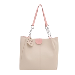 Minimalist cream and pink tote bag with metal chain handles and cartoon cat charm