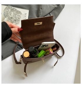 Macro view of the spacious inner compartment of the brown leather crossbody bag