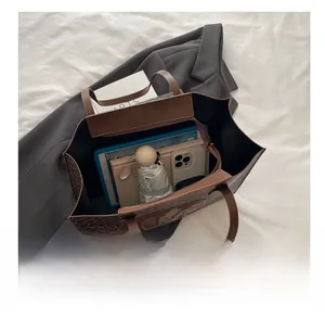 Deep brown tote bag showing spacious interior with tablet and daily essentials