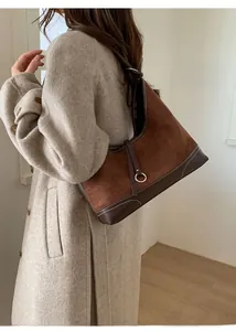 Detailed view of the large caramel suede tote bag with contrast white stitching detail