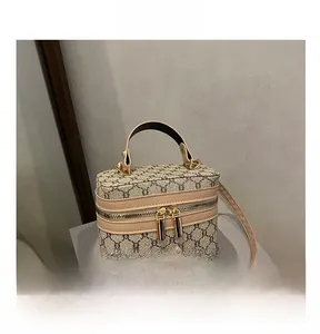 Detail of vintage monogram box bag featuring gold-tone zippers and top handle