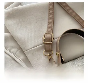 Detail of adjustable strap with gold-tone buckle on vintage printed box bag