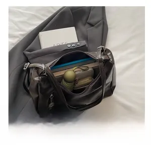 Macro shot of dark brown leather bag interior showing large capacity for books and umbrella