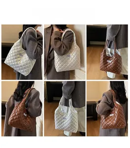 Close-up of quilted tote bag showing shiny metallic texture and fashion square label