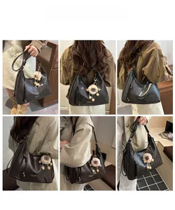 Model wearing a large black leather hobo bag with a plush charm in various styles