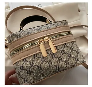 Detailed close-up of the smooth double golden zippers on the vintage monogram box bag