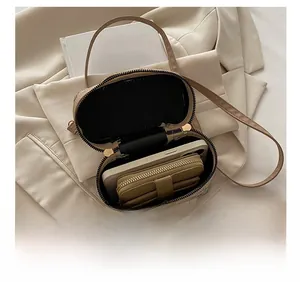 Interior view of small crossbody box bag showing capacity for phone and card holder