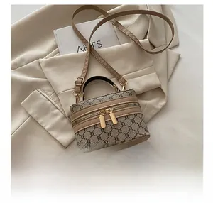 Close-up of vintage monogram mini handbag with top handle and double zipper details
