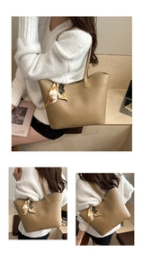 Detail of khaki tote bag featuring printed silk scarf handle and spacious interior