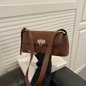 Brown vintage baguette bag in leather and suede patchwork with gold twist lock