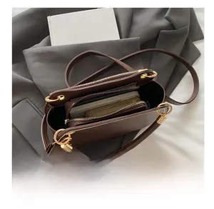 Detail view of brown PU leather tote bag interior showing large capacity for wallet and phone