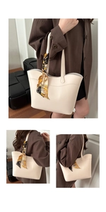 Detail of cream leather tote bag with printed silk scarf handle on a model's shoulder