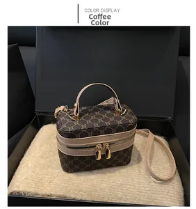 Detail of coffee-colored box bag with pattern in a luxury gift box with plush lining