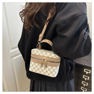 Detail of vintage patterned crossbody box bag shown on model for size perspective