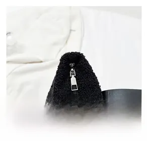 Detail of black plush bucket bag showing premium silver metal zipper and faux fur texture
