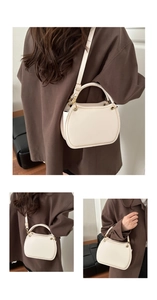 Detailed close-up of cream crescent bag with gold-tone hardware and smooth vegan leather