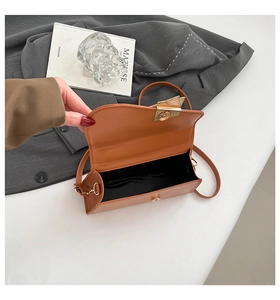 Detail of caramel leather crossbody bag interior with magnetic closure and inner lining