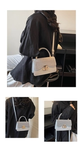Detail of light grey vintage crossbody bag with gold ring buckle and animal texture