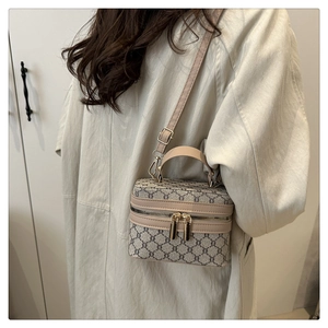 Detail of vintage box crossbody bag with grey monogram canvas and leather handles