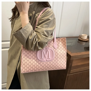 Pink faux leather tote bag with M-letter monogram print and adjustable shoulder strap
