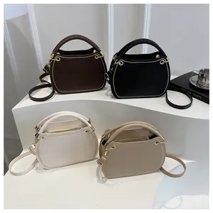Detail view showing minimalist shoulder bags in four colors with gold ring hardware