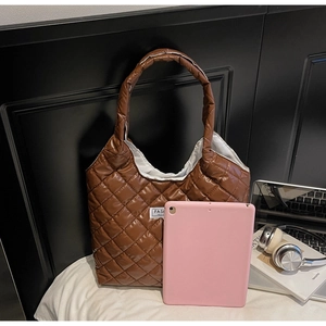 Deep brown quilted tote bag with FASHION label showing large capacity and puffy texture