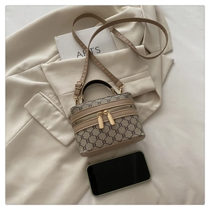 Macro detail of vintage monogram box bag with golden zippers and leather strap
