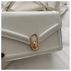 Detailed side view of white minimalist square bag with gold oval twist lock and V-stitch