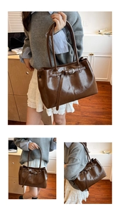 Detail of dark brown vintage tote bag with glossy finish and silver metal buckle accent