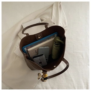 Brown leather tote bag interior view showing large capacity for laptop and essentials