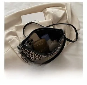 Detailed interior view showing handbag capacity for phone, wallet, and cosmetics