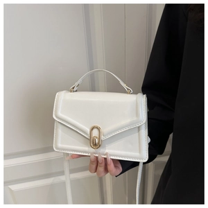 Detail of white leather crossbody bag with golden oval turn-lock and envelope flap