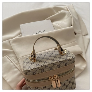 Detail of vintage monogram box bag with dual zippers and gold hardware accents