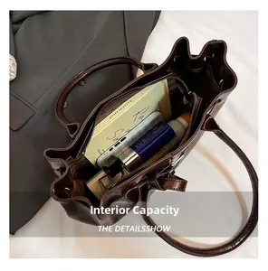 Interior view of deep brown leather tote bag showing large capacity and zipper pocket