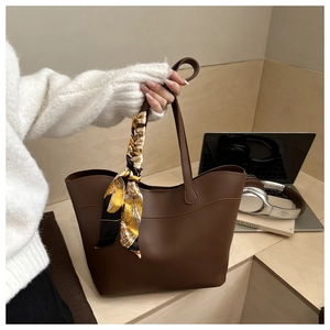 Deep brown textured tote bag with silk scarf detail, ideal for daily business commute