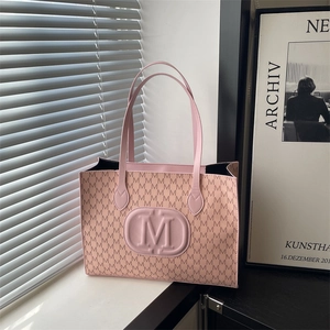 Pink Japanese Harajuku style tote bag with repeating M-letter print and round logo detail