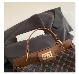 Gros plan d'un sac à main vintage marron avec poignée en cuir et fermoir doré