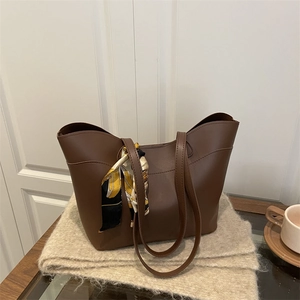 Brown faux leather tote bag with stylish printed silk scarf on high-quality handle