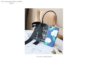 Black and white tweed handbag with large bow showing size comparison to a smartphone