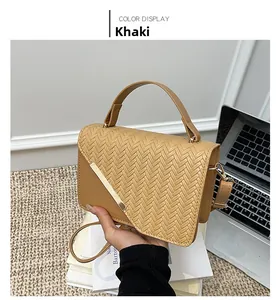 Detail view of khaki crossbody bag featuring a woven herringbone texture on the flap
