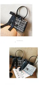 Close-up of black and white tweed crossbody bag with large satin bow and silver buckle