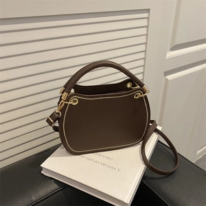 Elegant dark brown leather handbag with gold hardware and shoulder strap on a white background