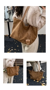 Macro detail of caramel brown suede tote bag with fine stitching and pendant charm