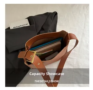 Top view of brown bucket bag interior showing large capacity for tablet and notepad