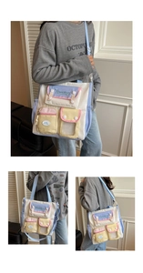 Close-up of contrast color canvas tote bag featuring multi-pocket design and long straps