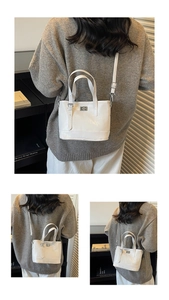 Detail showing white PU leather bucket bag with silver buckle and adjustable shoulder strap