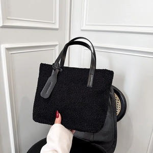 Fashionable black fuzzy bucket bag with leather handles for women autumn style