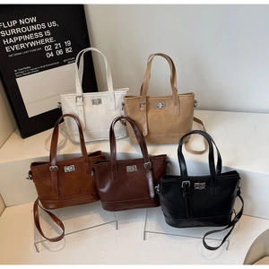 Detailed view of bucket shoulder bags in five colors with silver swivel locks