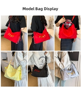 Detail of large nylon tote bags in four colors with side drawstring and letter print