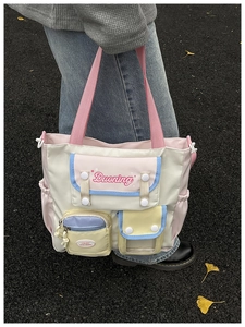 Detail of color-block tote bag with functional pockets and Duoning logo print
